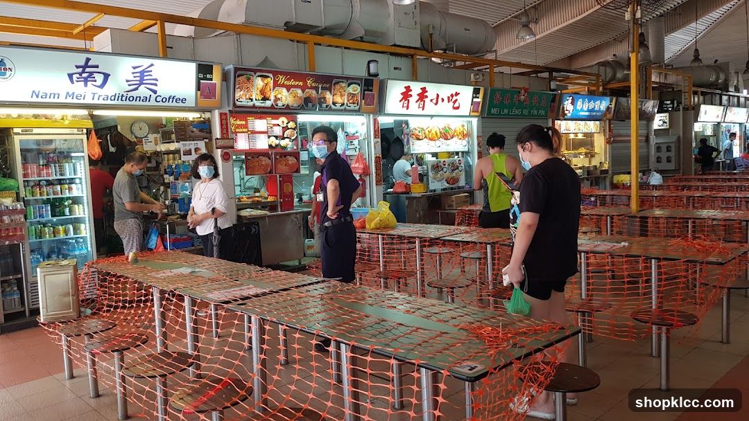 Food court with tables covered in orange netting