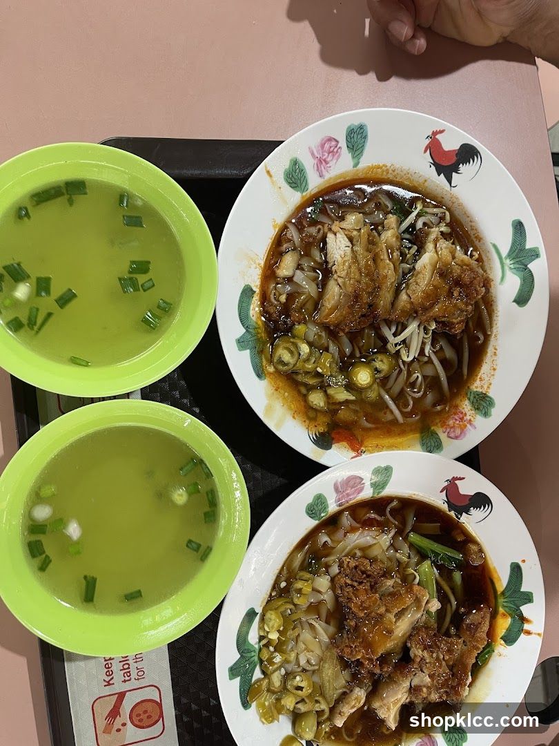 Two bowls of noodles with soup