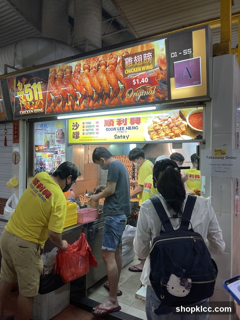Food stall with chicken wings and satay