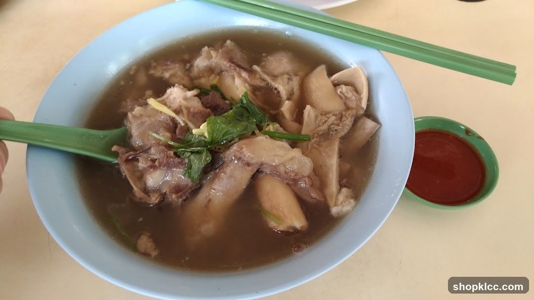 Bowl of Meat Soup with Chili Sauce
