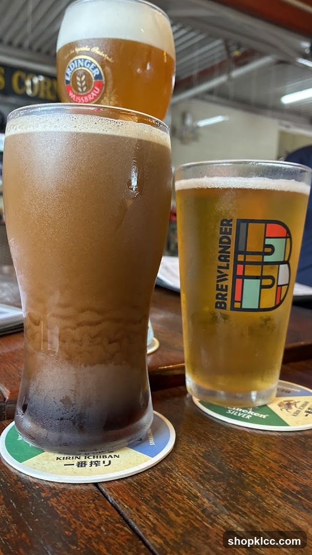 Three glasses of beer on a wooden table
