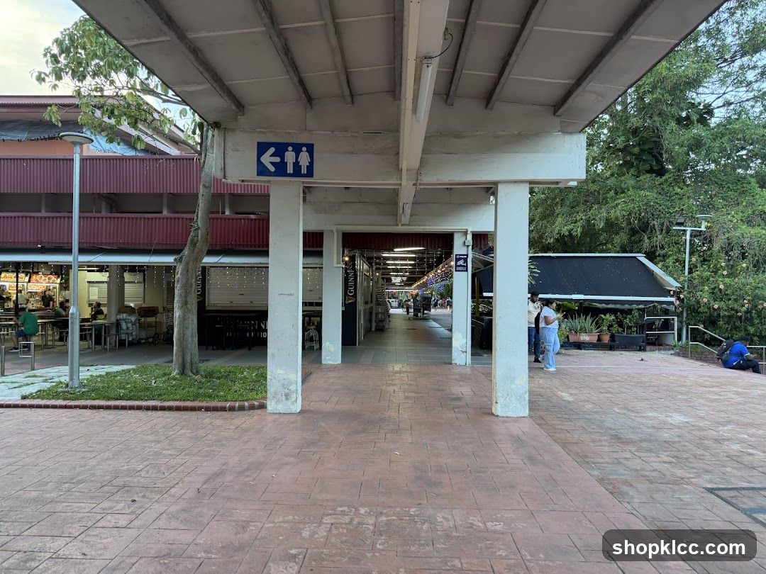 Covered walkway with shops and greenery