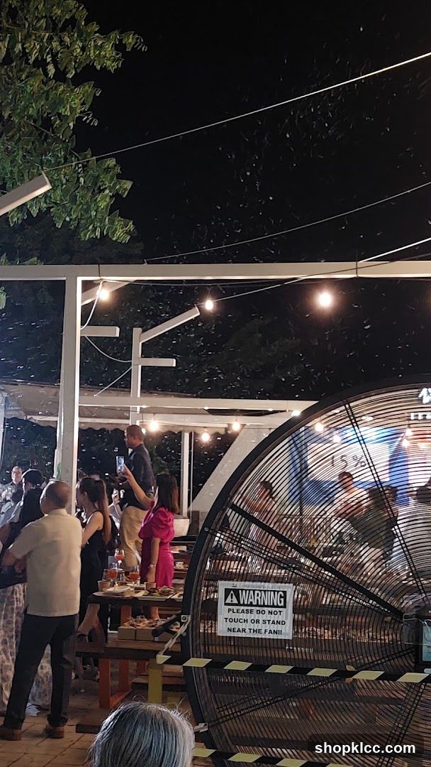 Outdoor gathering with a large fan