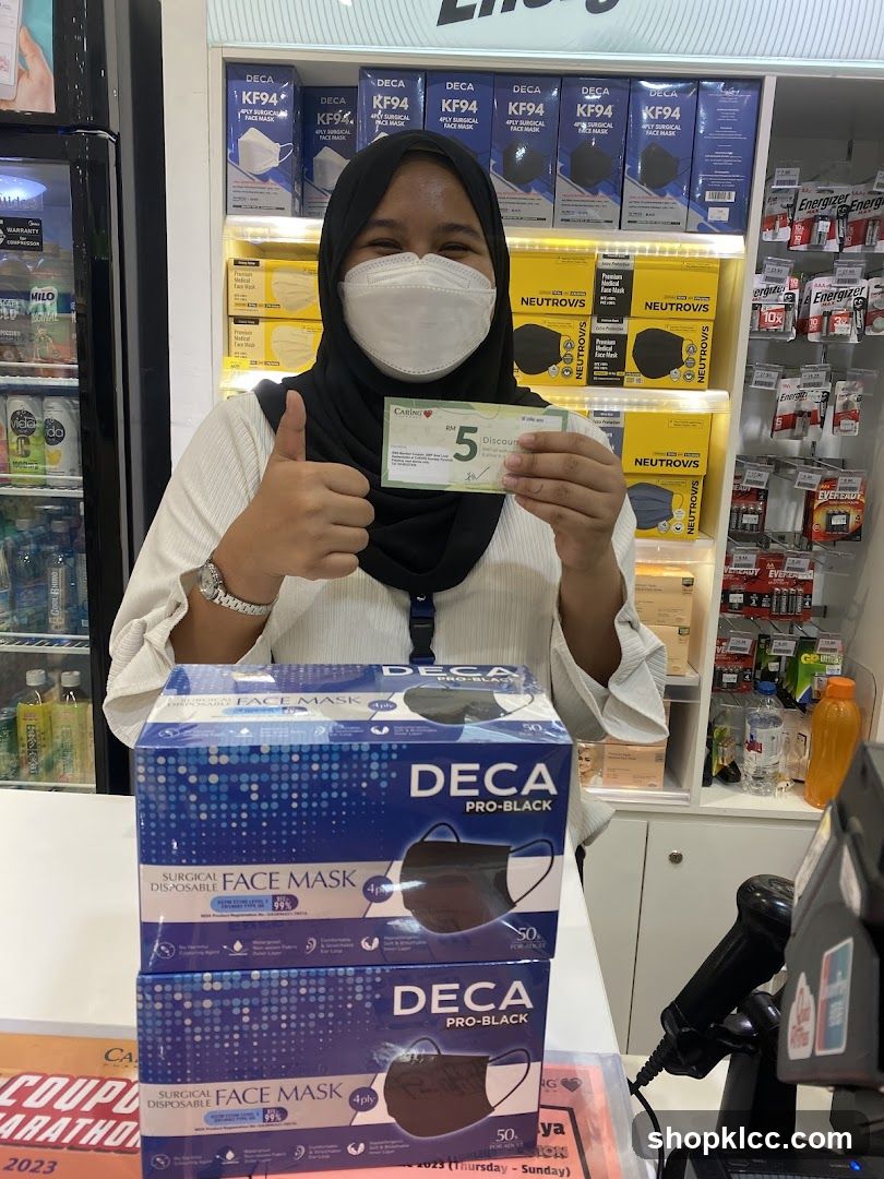 Woman holding a discount coupon and showing boxes of face masks