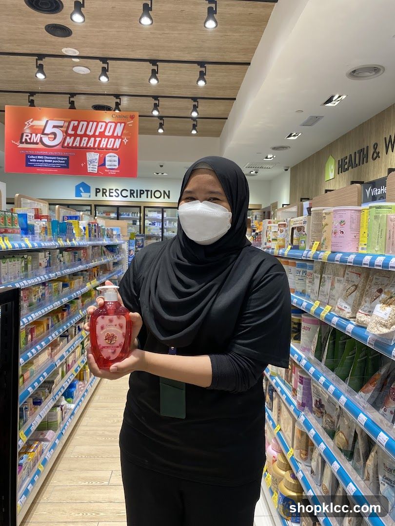 Woman holding a bottle of hand soap in a pharmacy