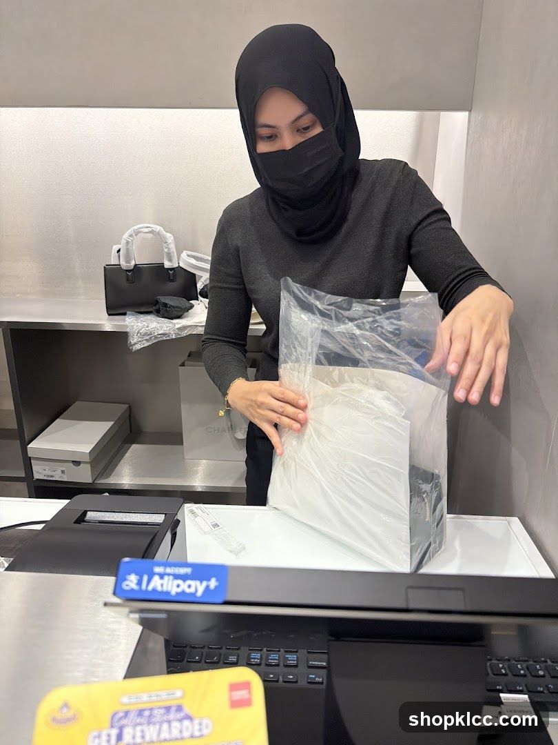 Sales associate packaging a handbag