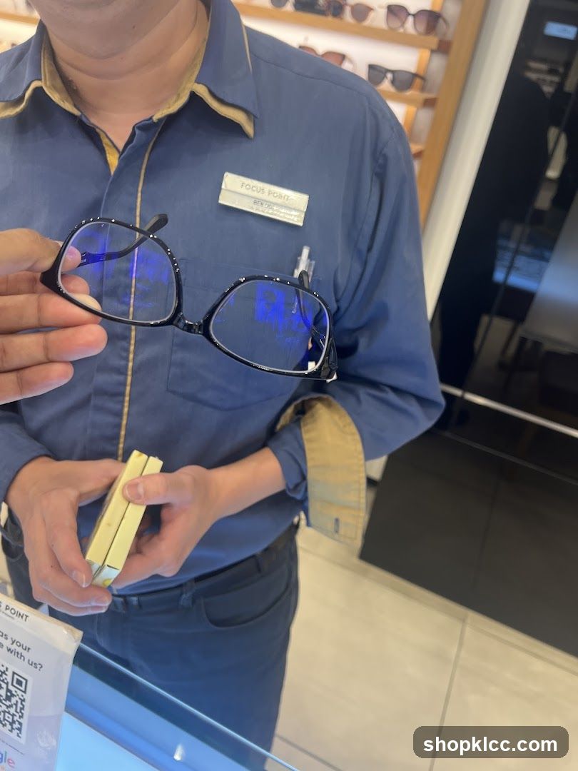 Optician holding glasses
