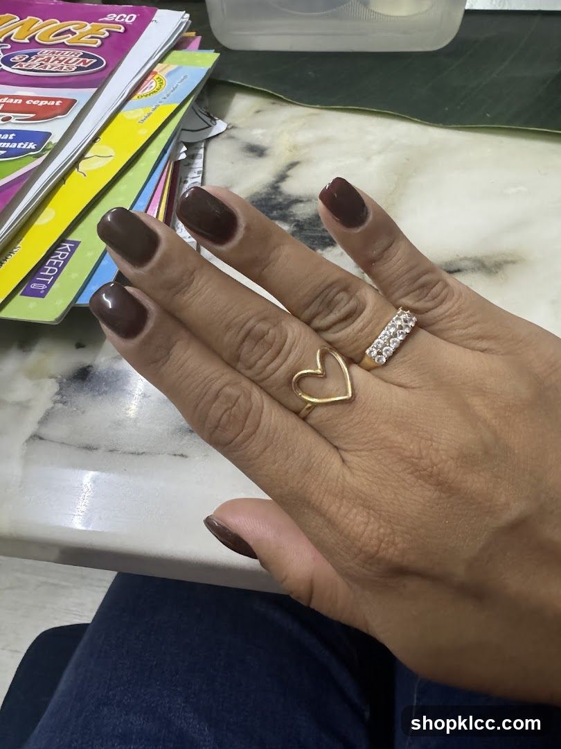 Woman's Hand with Rings and Dark Nail Polish