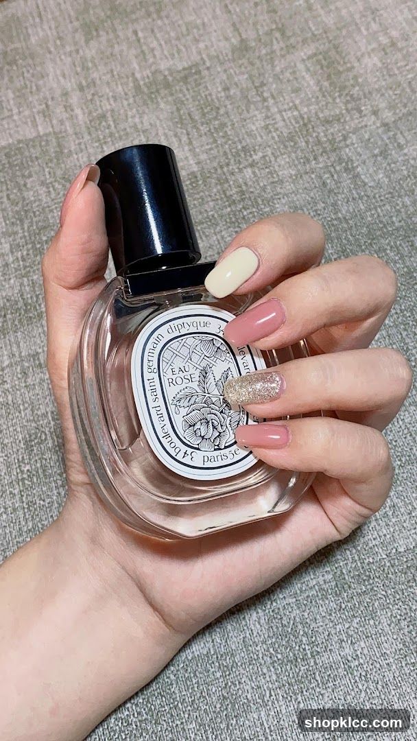 Perfume Bottle and Manicured Hand