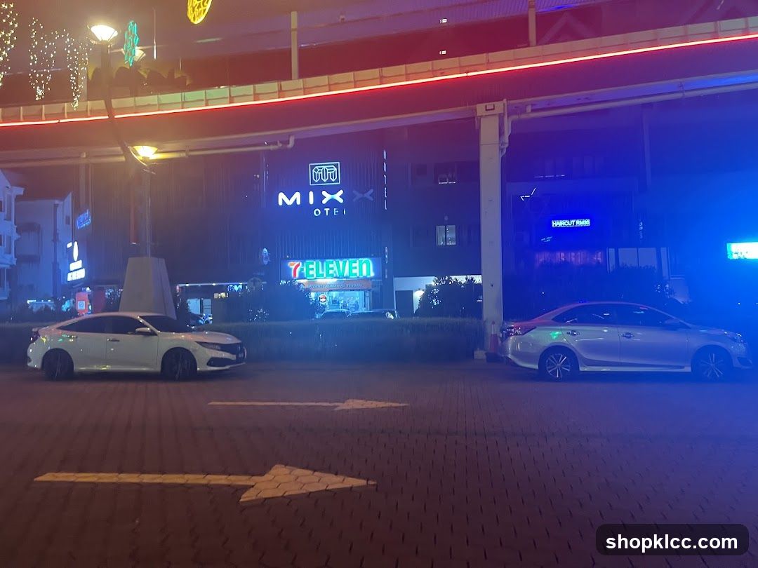 Nighttime street scene with businesses and cars