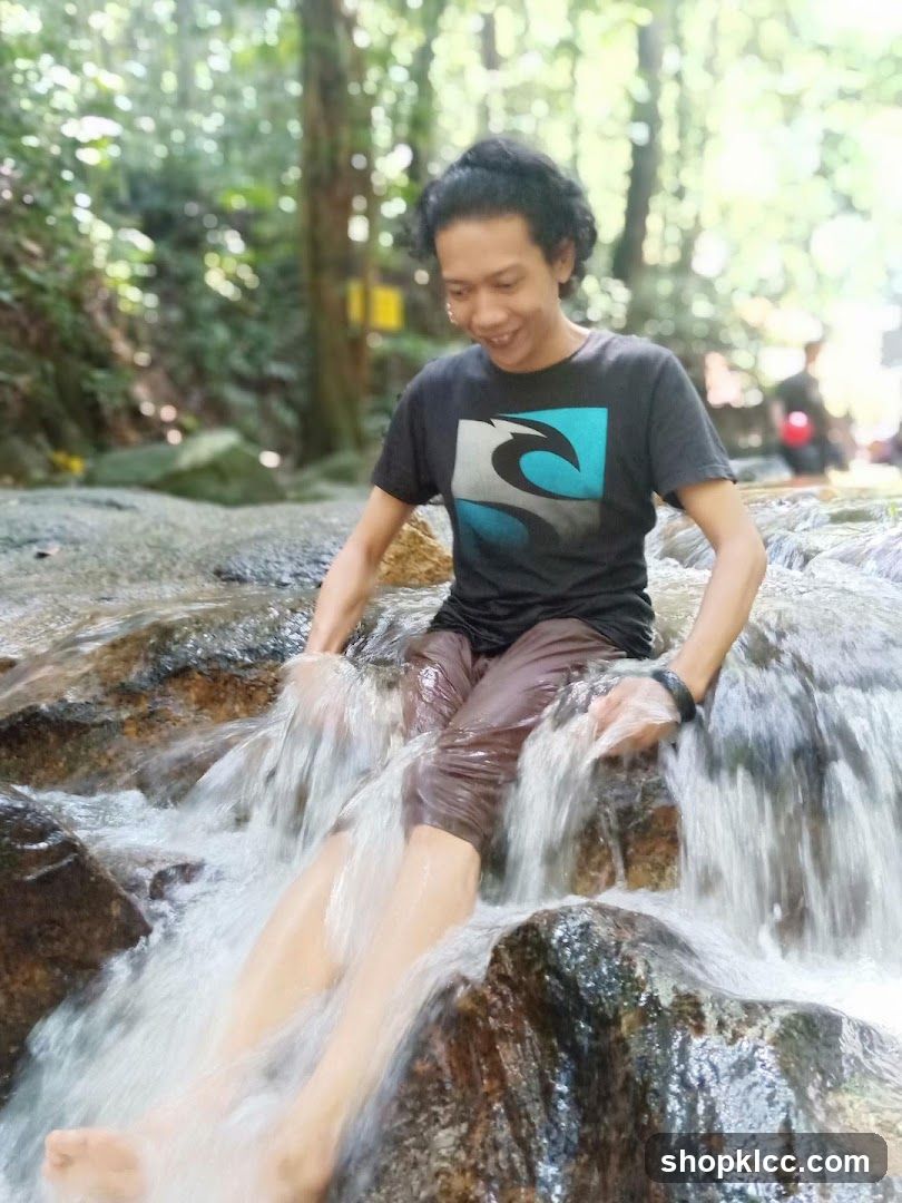 Man sitting in a waterfall