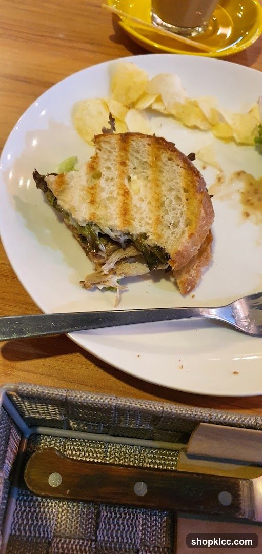 Half-eaten sandwich with chips