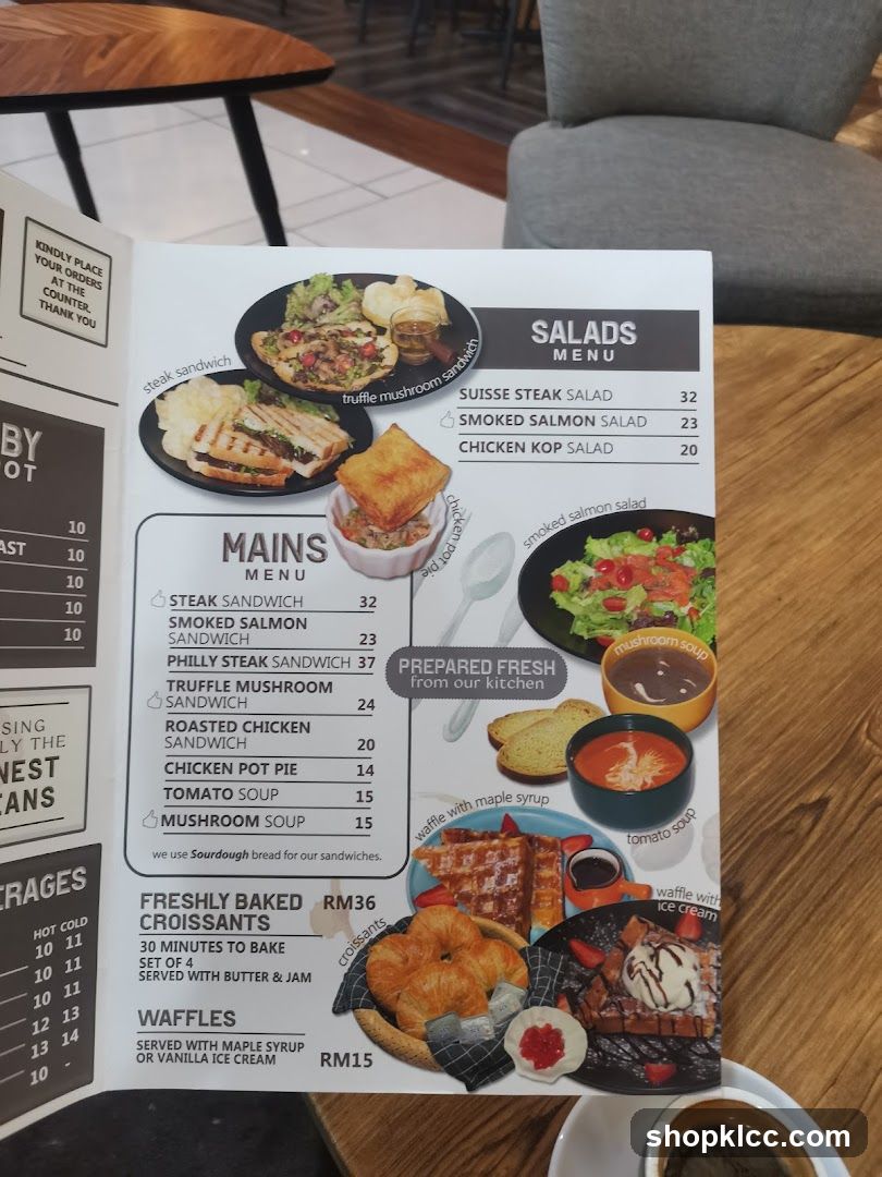A menu featuring mains, salads, croissants, and waffles.