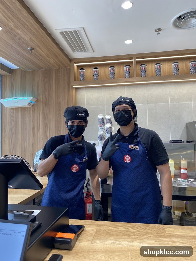 Two staff members behind a counter