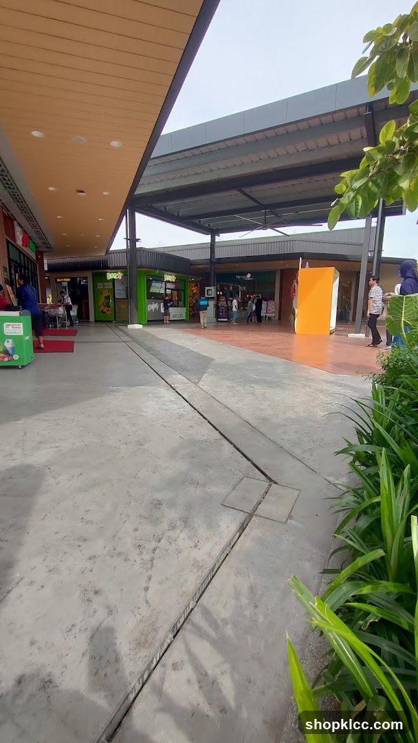 Outdoor shopping area with various storefronts