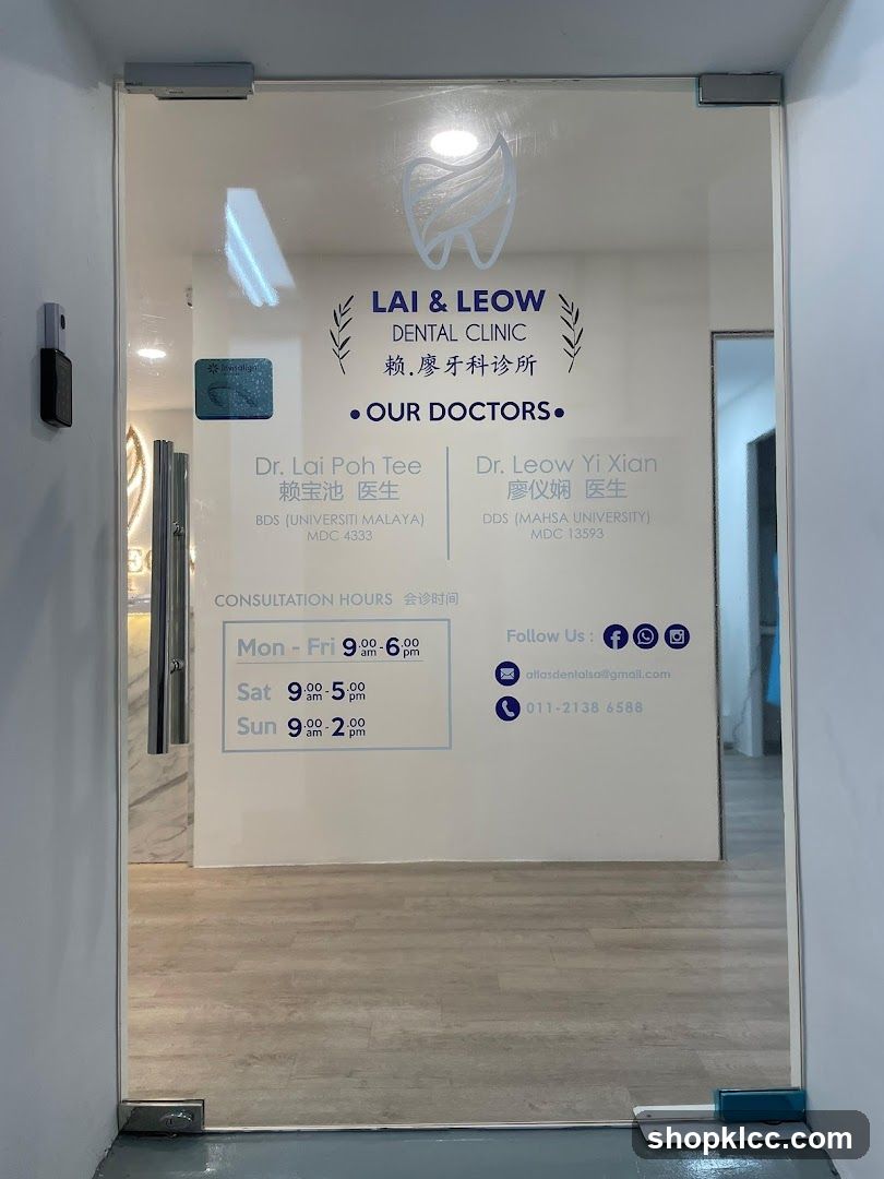 The image shows the glass entrance of Lai & Leow Dental Clinic. The clinic's name, logo (a stylized tooth), and information about their doctors are displayed on the glass door. It also lists consultation hours and contact details.