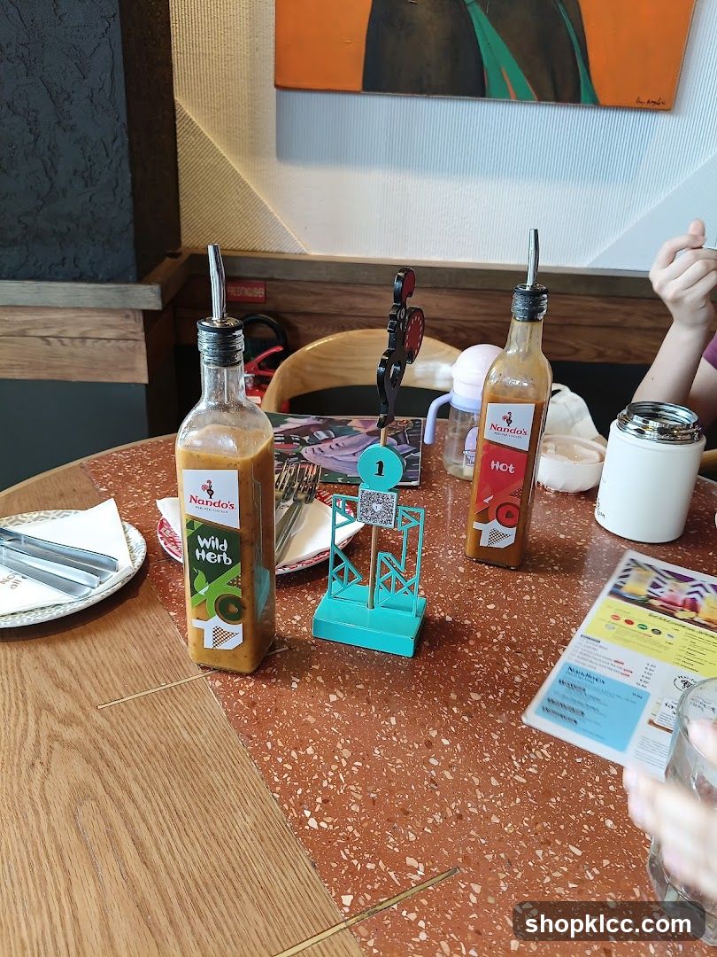 Table setting with Nando's sauces and menu