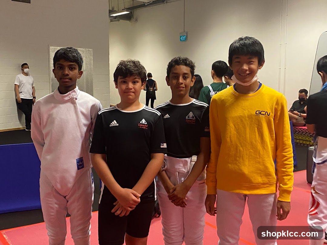 Four young fencers posing for a photo