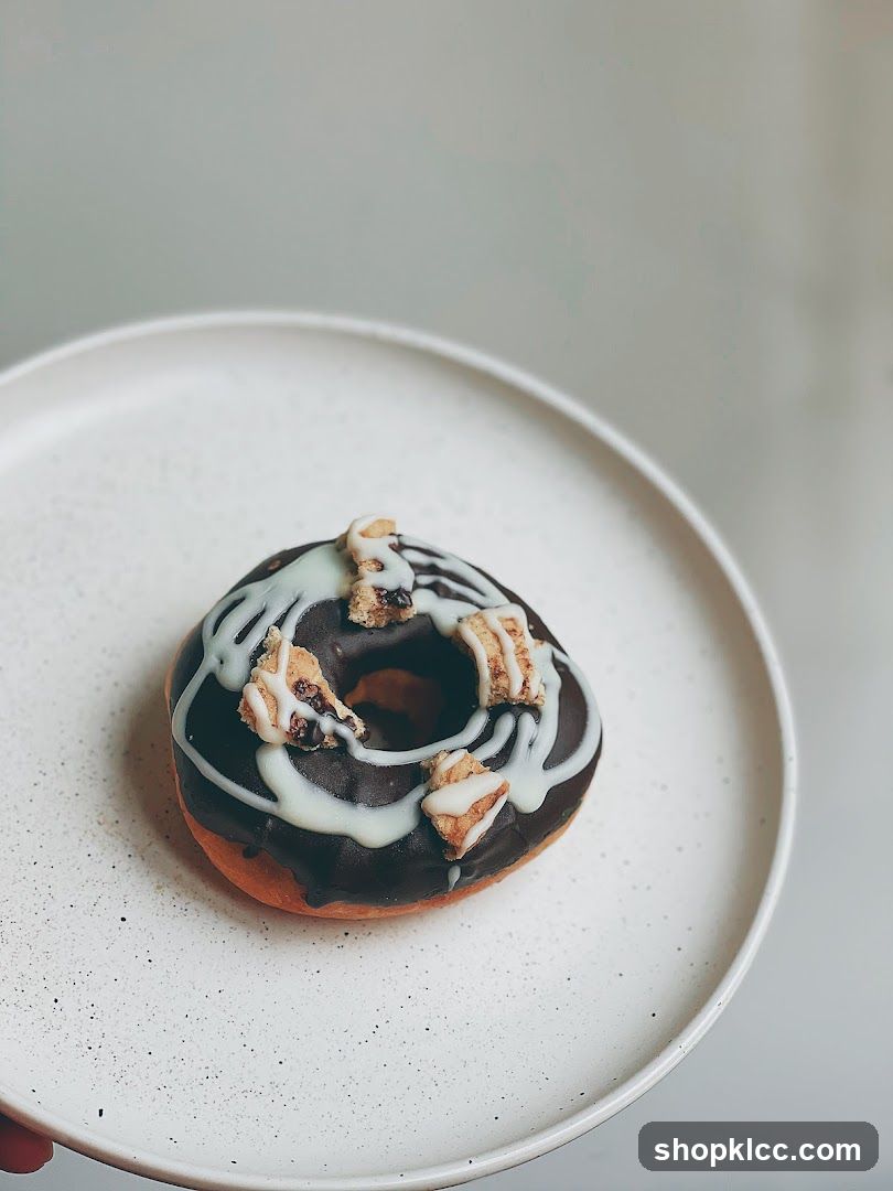 Chocolate Glazed Donut with White Drizzle and Toppings