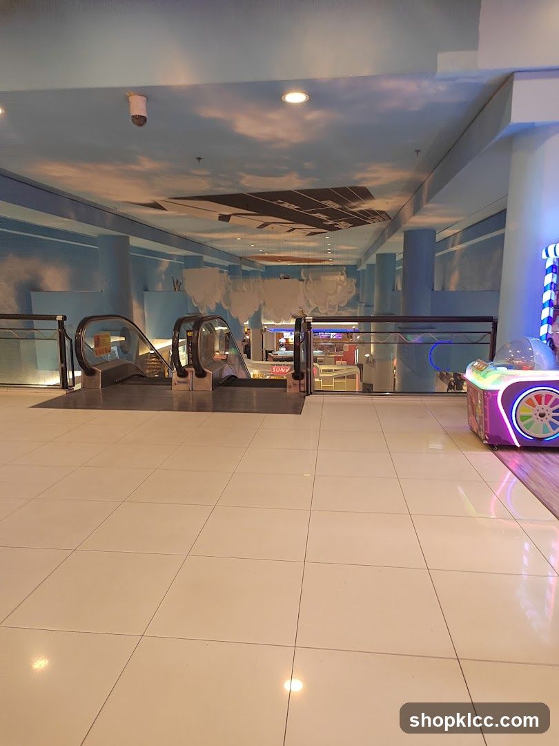 Indoor mall walkway with escalators and arcade game
