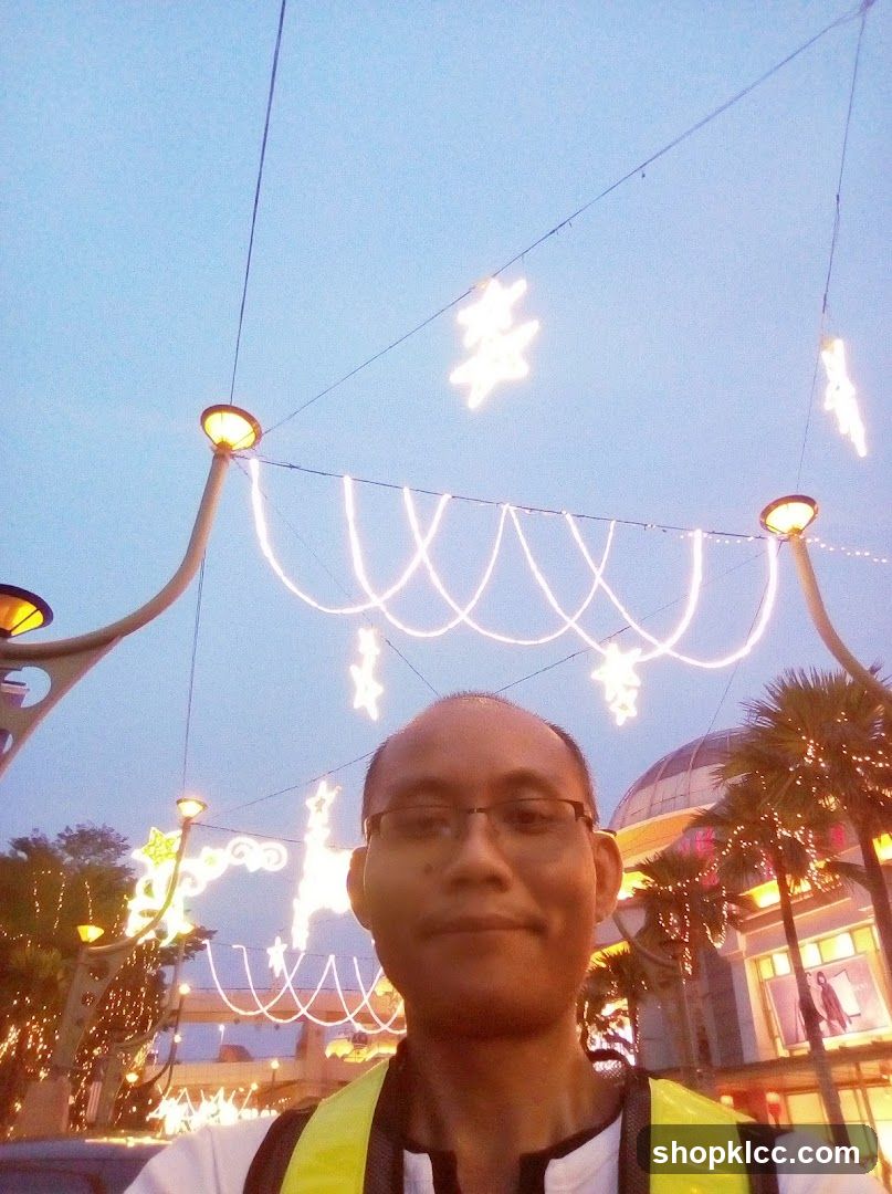 Man in front of illuminated decorations
