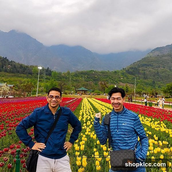 Two men posing in a field of tulips