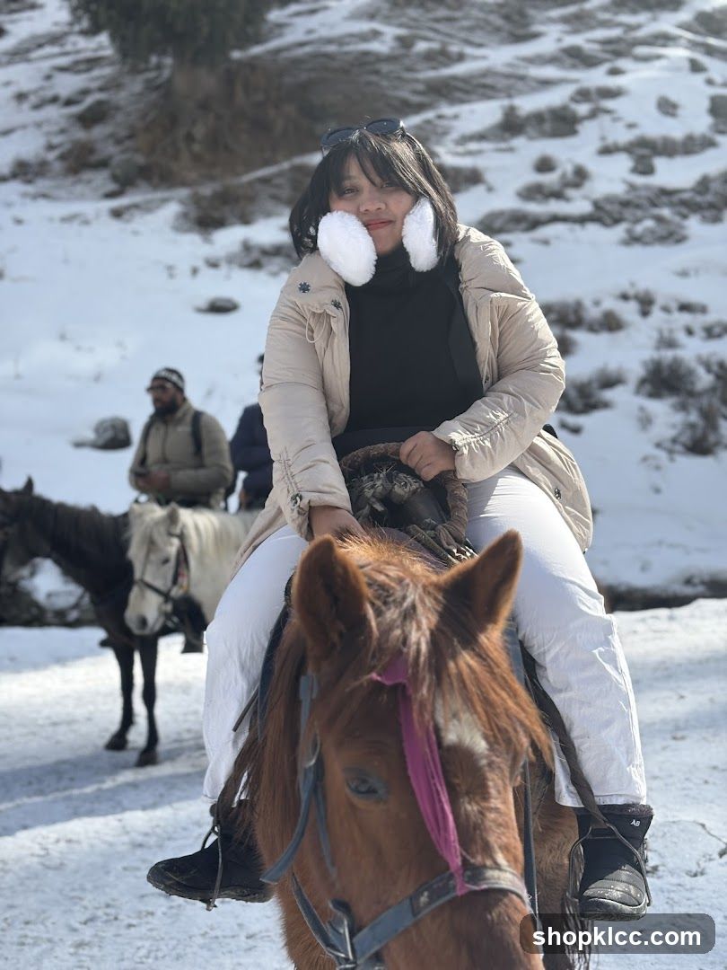 Woman on horseback in snowy landscape