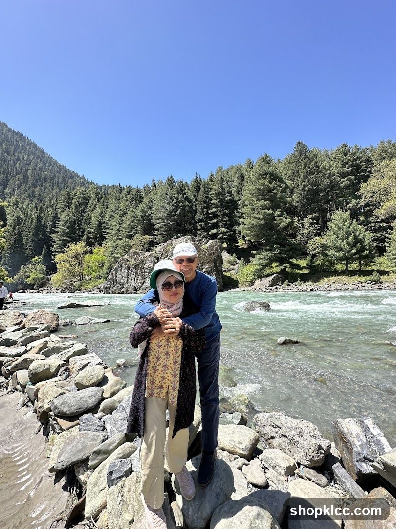 Couple posing by a river