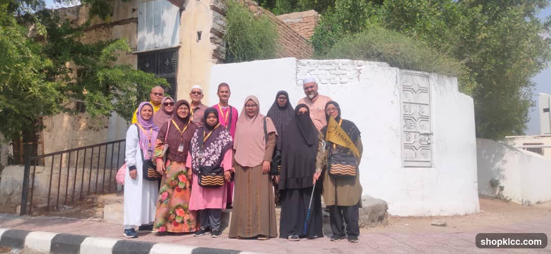 Group posing in front of old buildings