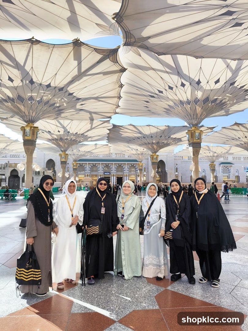 Group of women posing under large umbrellas
