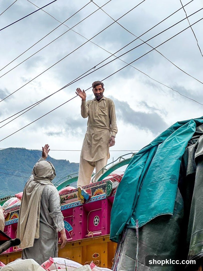Men waving from a truck
