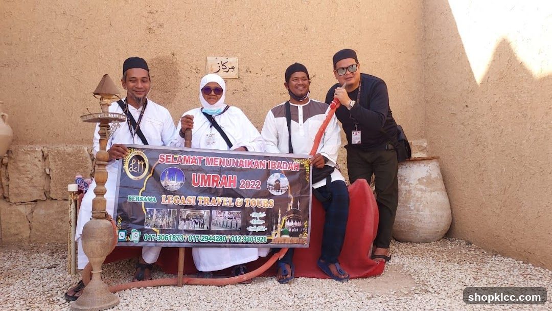 Group holding Umrah banner