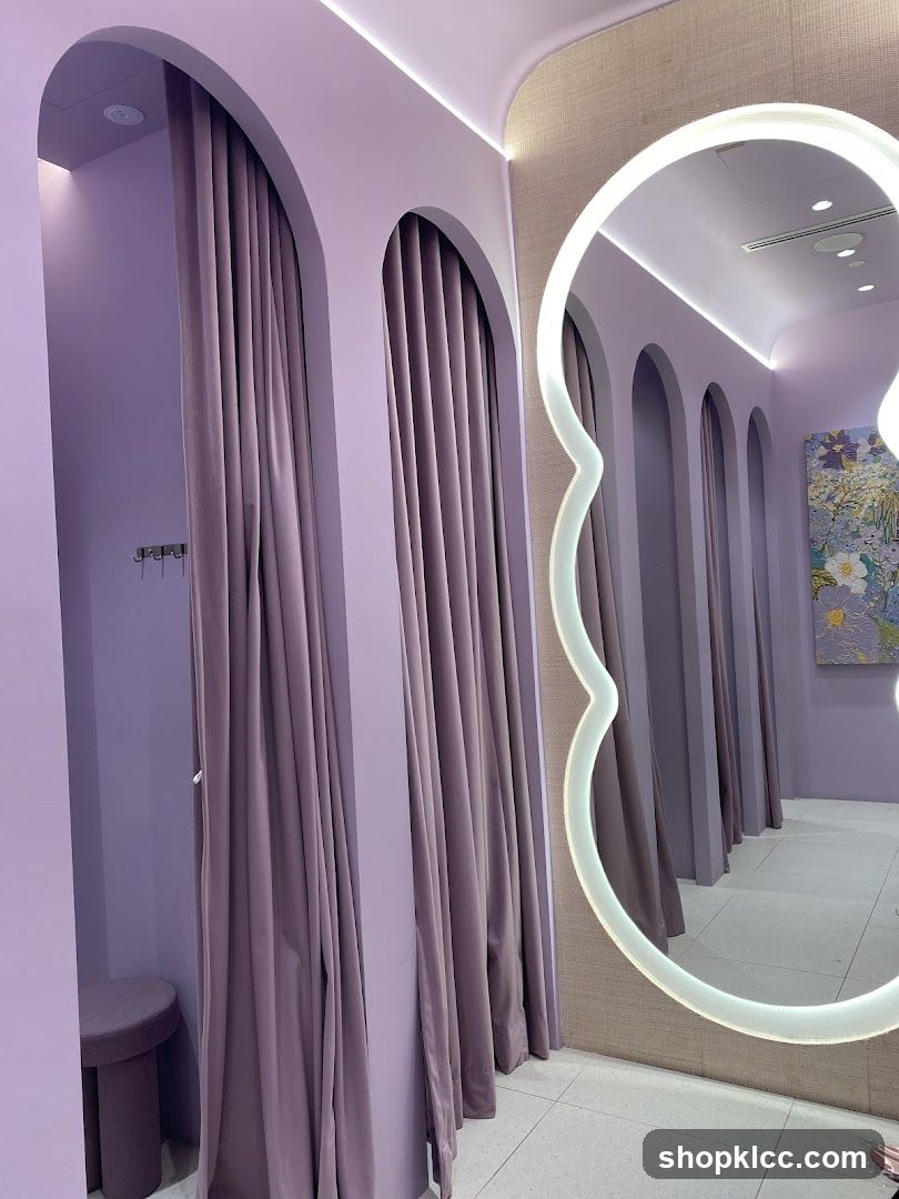 Fitting rooms with purple curtains and a decorative mirror