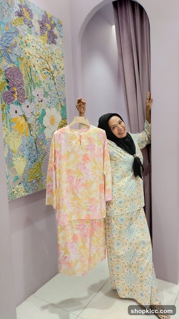 Woman holding a floral patterned outfit