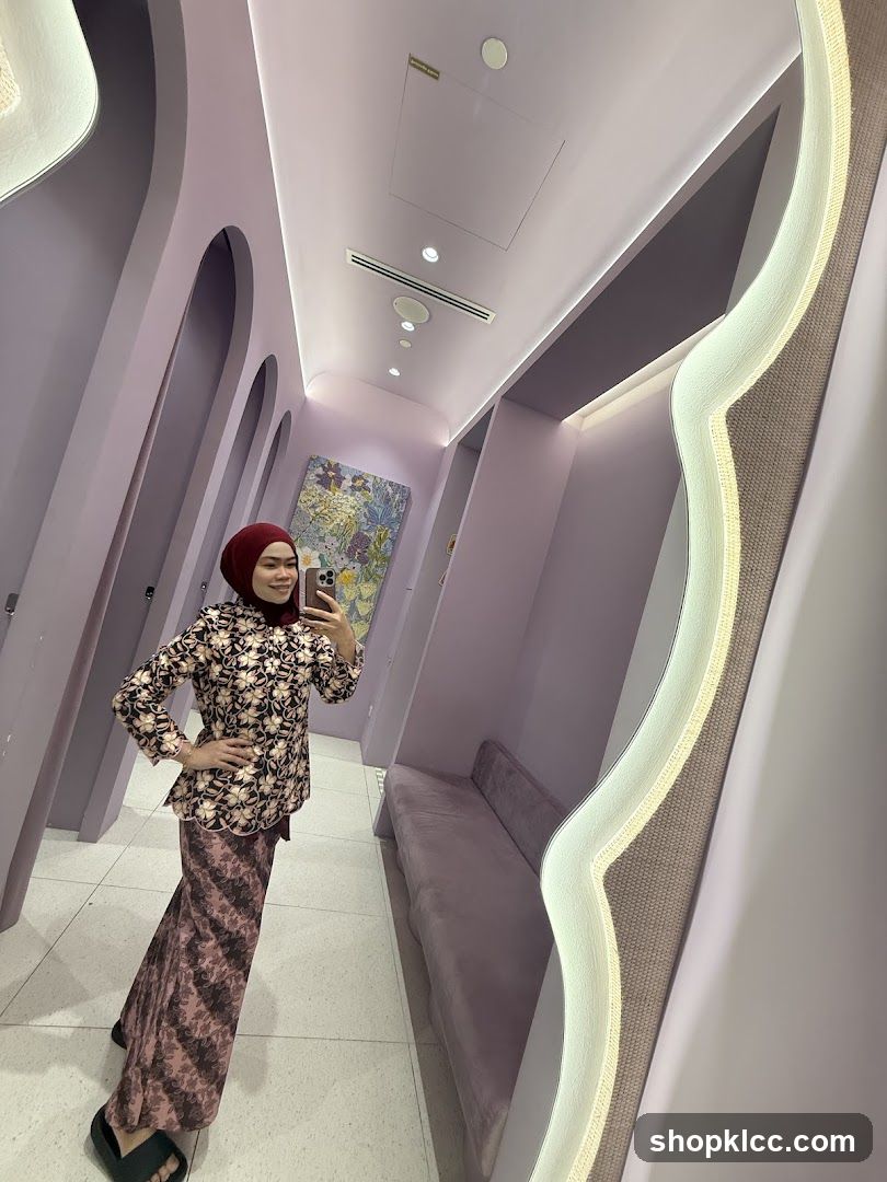 Woman in a patterned outfit taking a mirror selfie