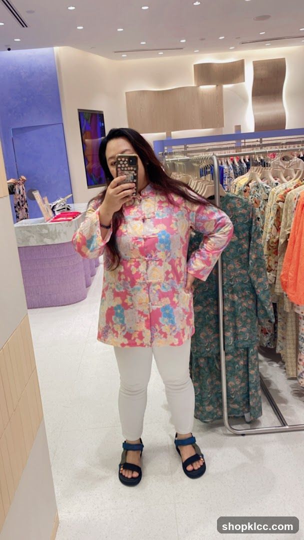Woman in floral jacket trying on clothes