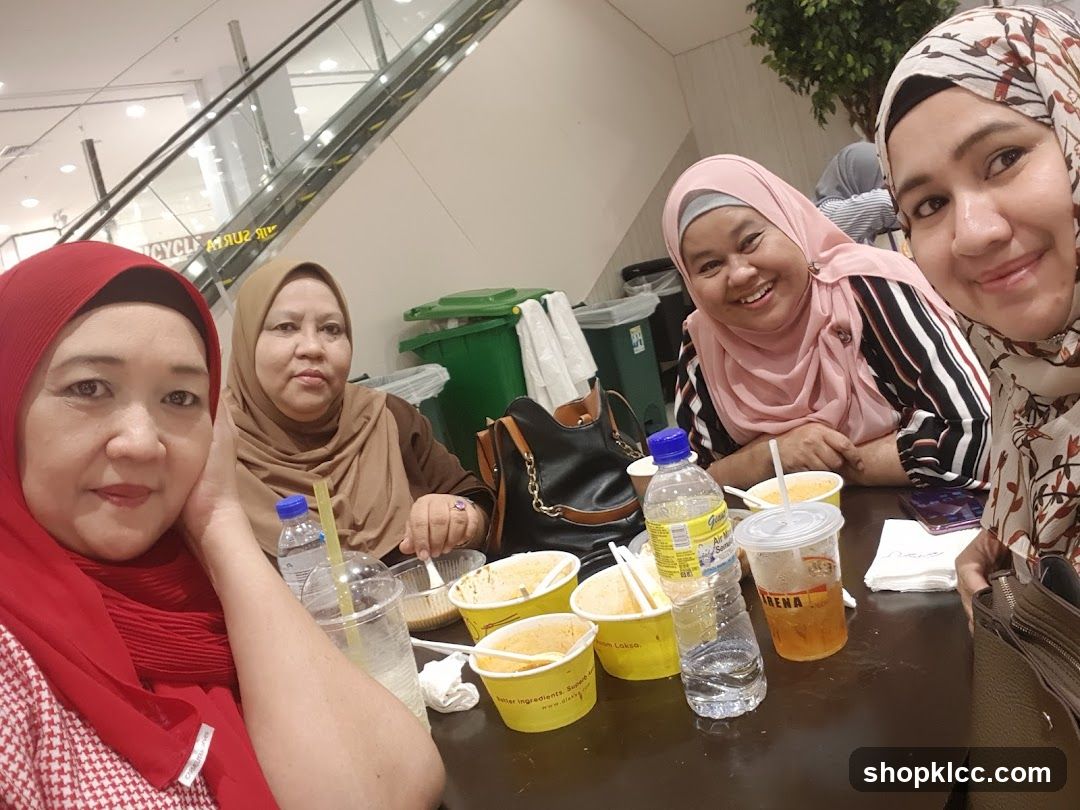 Four women at a table with food