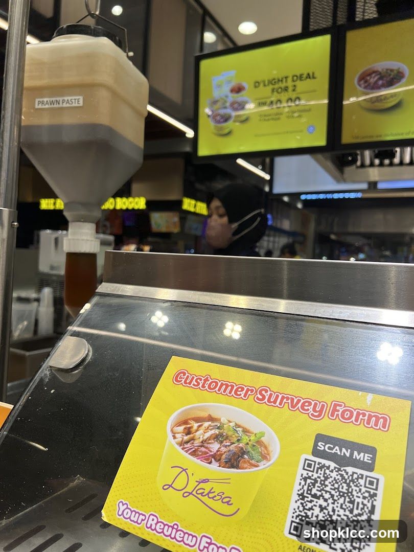 Food stall with prawn paste dispenser and promotional sign