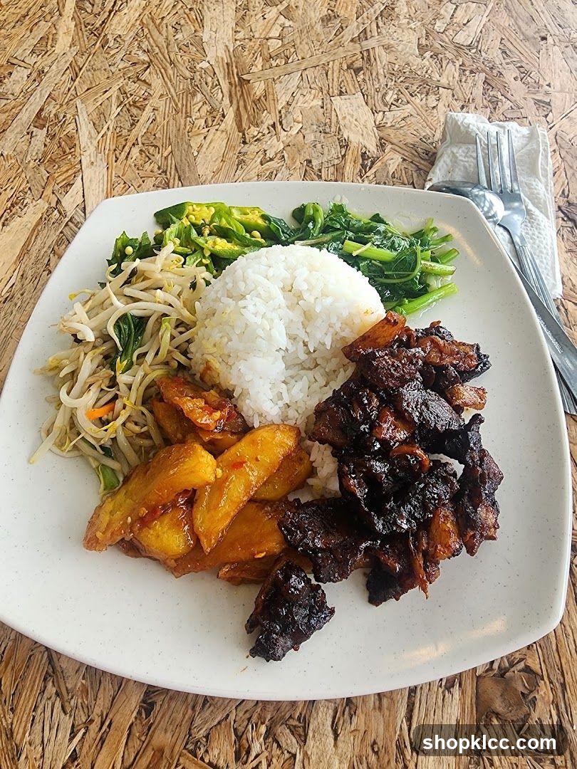 Plate of food with rice, vegetables, and meat