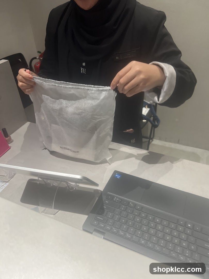 Employee holding a drawstring bag