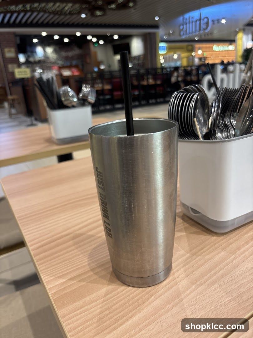 Metal Tumbler with Straw on Table