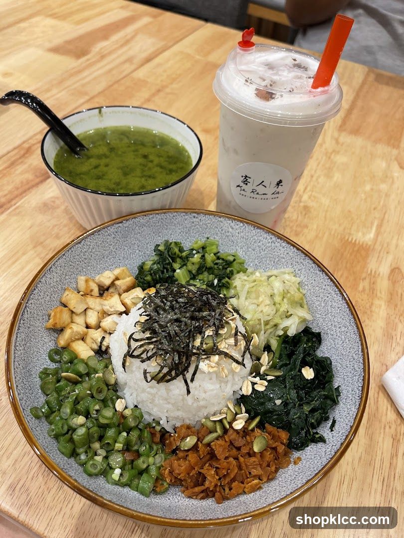 Rice bowl with various toppings and a drink