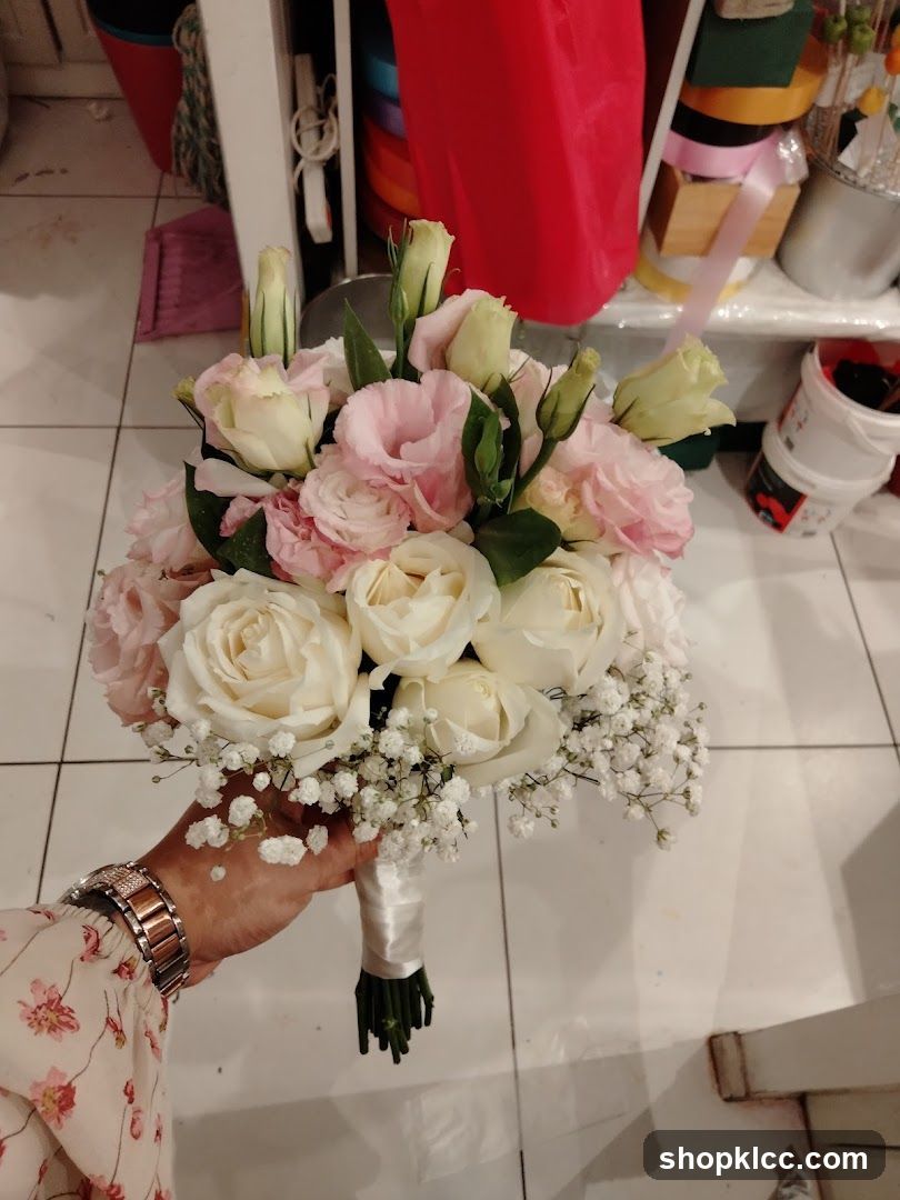 Hand holding a bridal bouquet