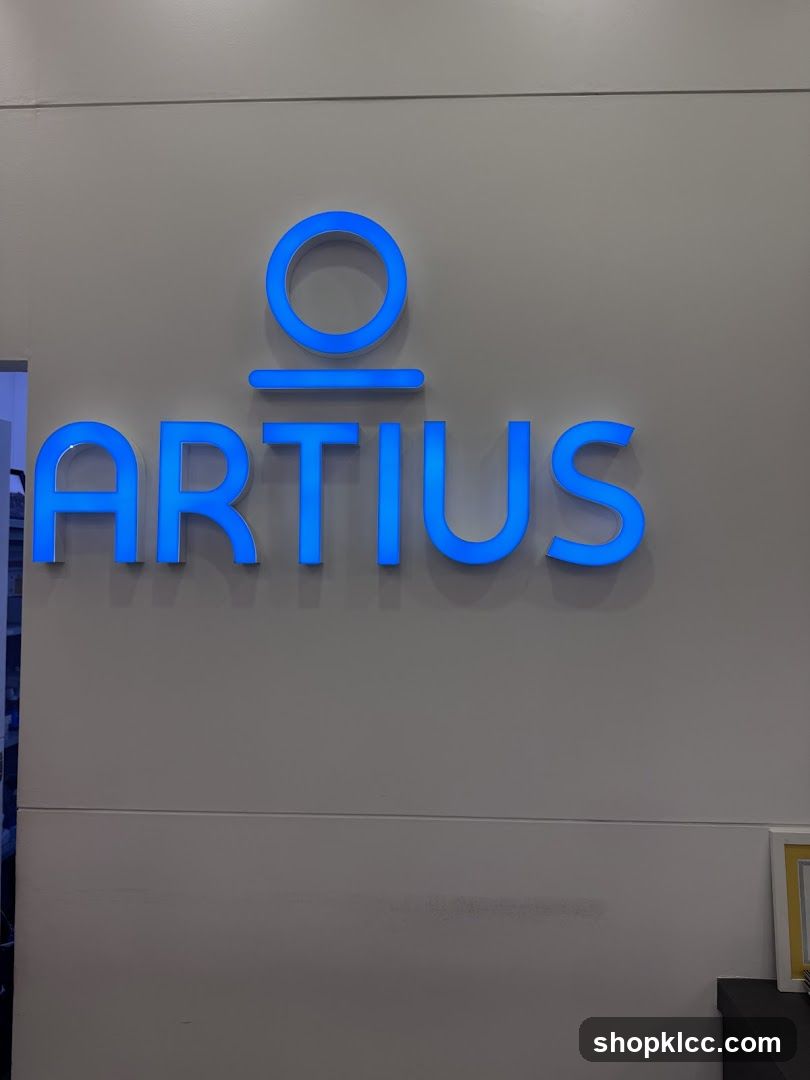 Blue illuminated logo on a wall
