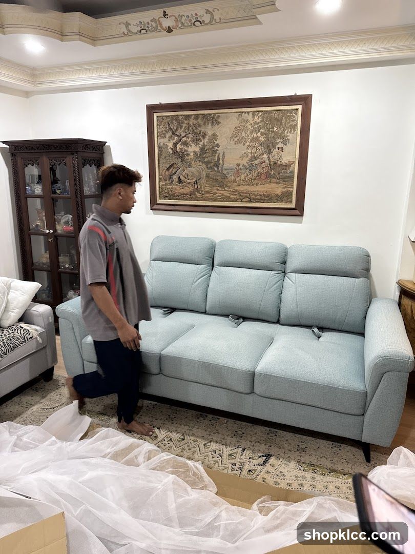 Man Unpacking a Sofa