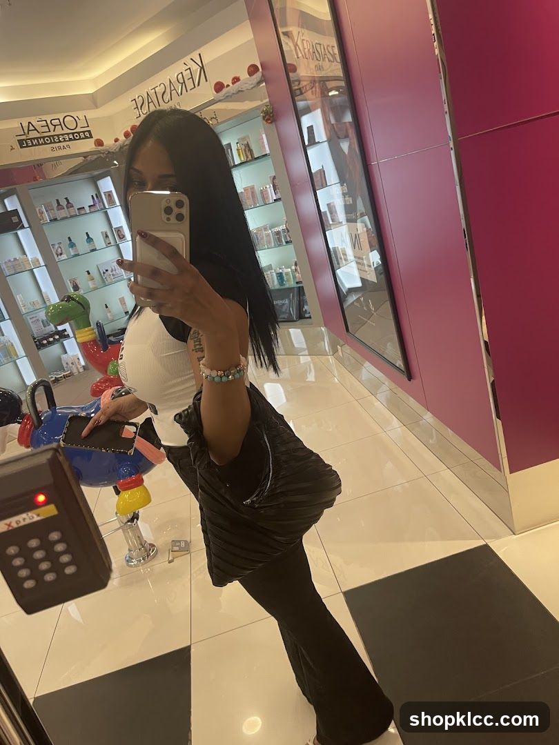 Woman taking a mirror selfie in a salon