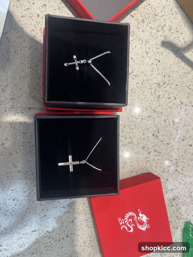 Two cross necklaces in boxes