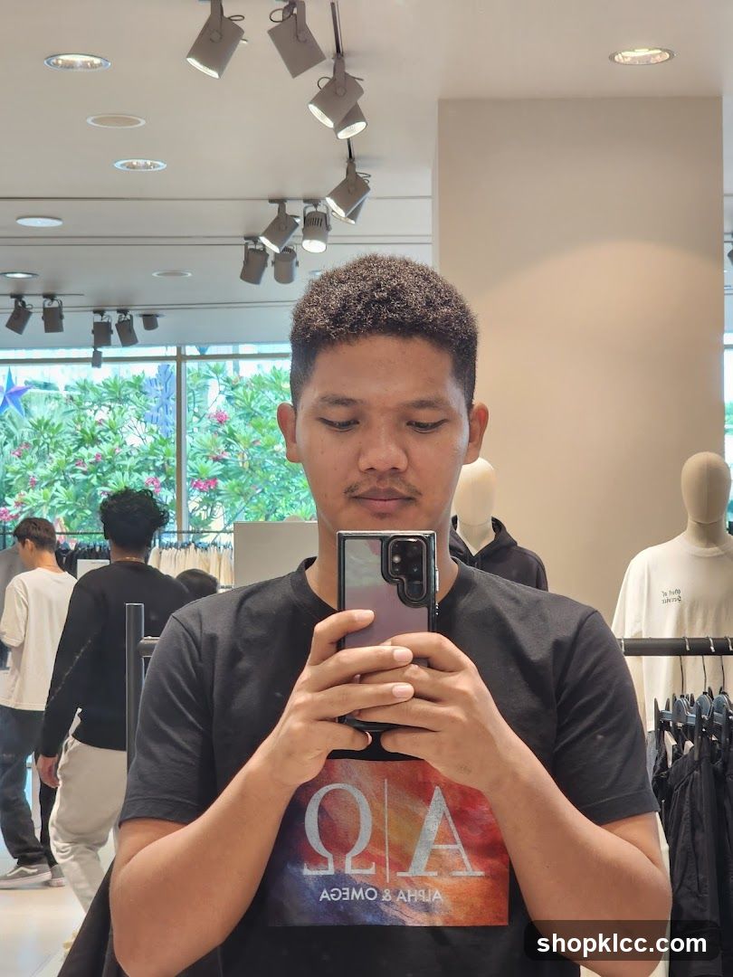Man taking a selfie in a clothing store