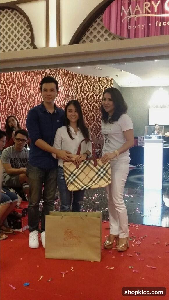 People posing with a handbag and shopping bag