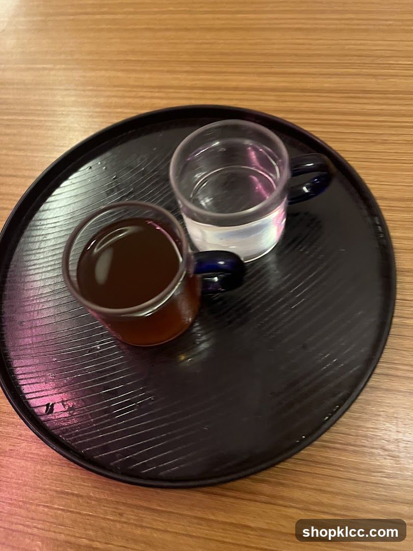 Two small glasses of drinks on a tray